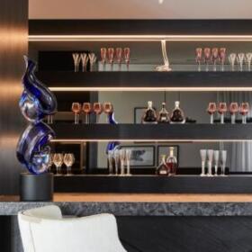 Bespoke cellar and bar interior design by Lewisham Interiors, Melbourne – custom joinery with glassware display and sculptural lighting